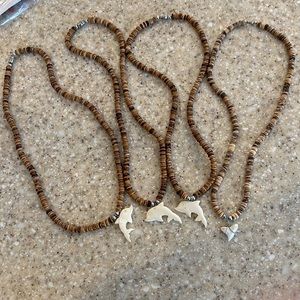 Beach necklaces 4 total. 3 dolphin 1 Sharks tooth